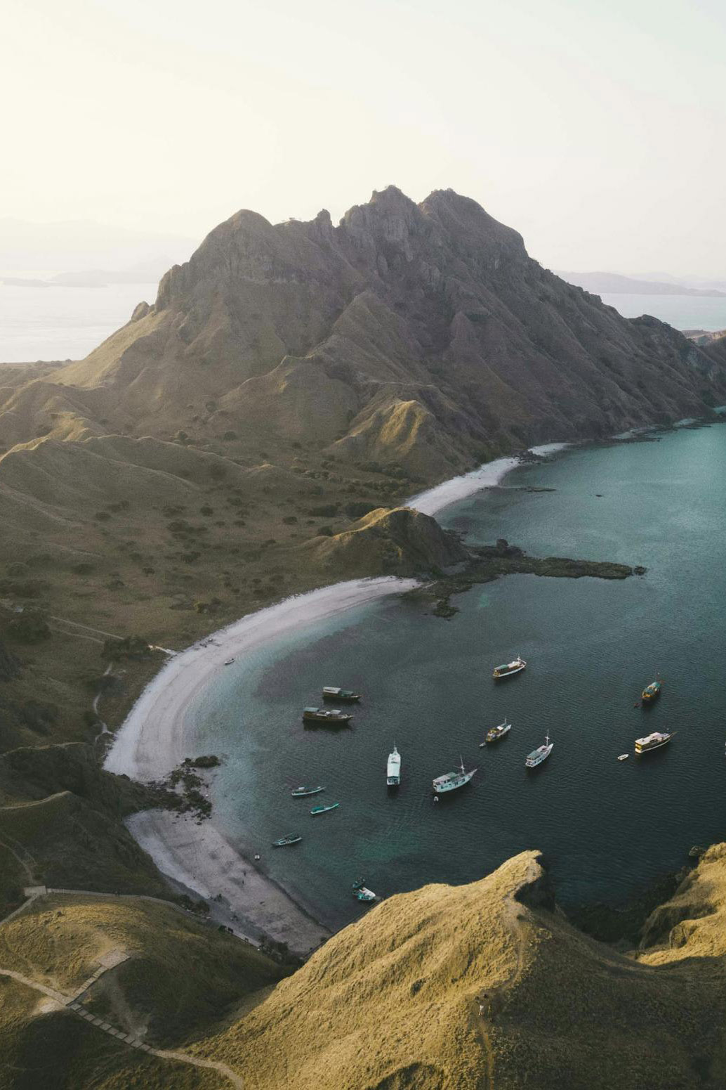 boats floating on water near island in indonesia boats floating on water near island in indonesia