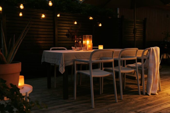 cozy evening garden terrace table with lighting and candles