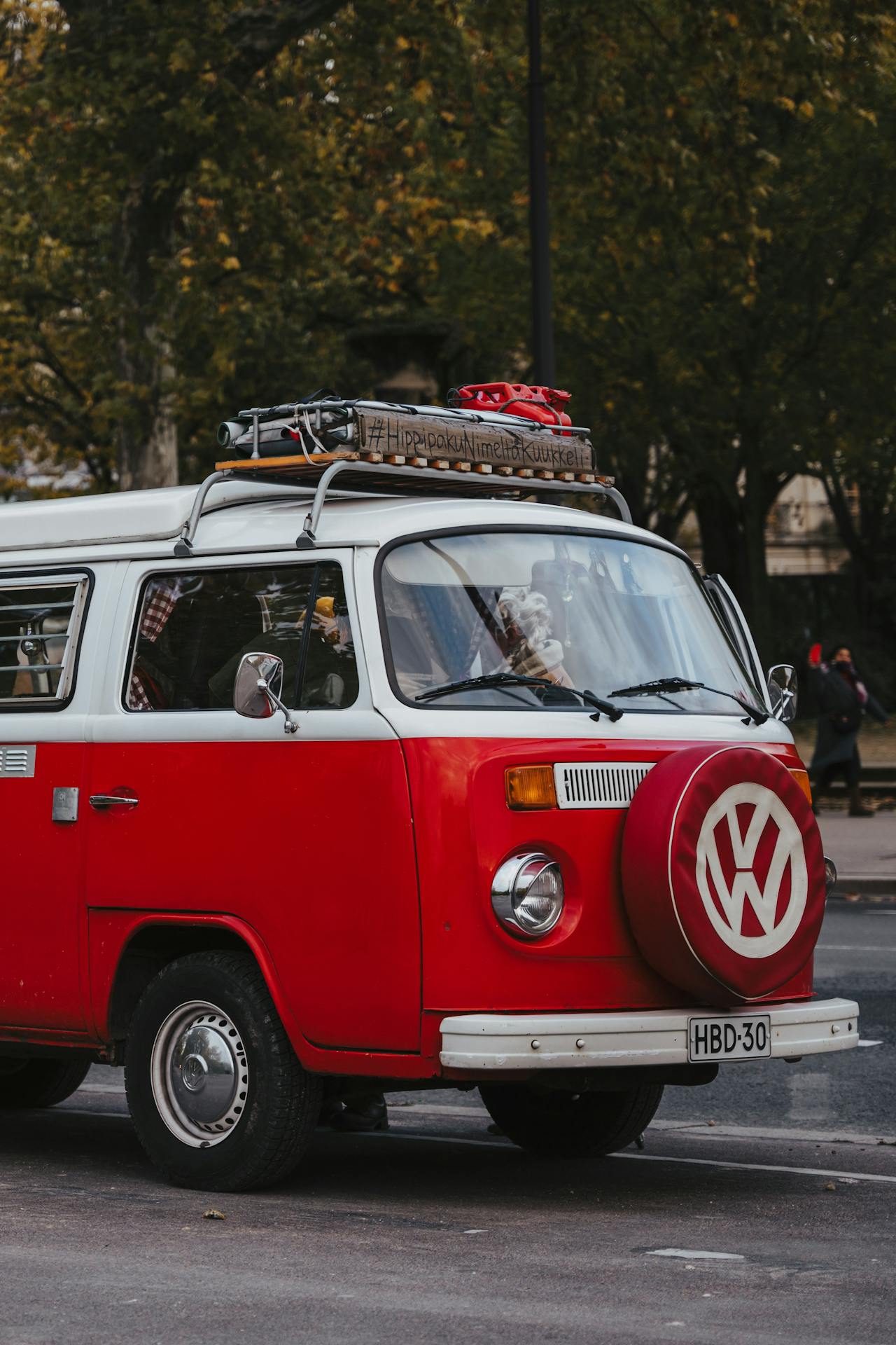 retro volkswagen campervan minivan in red in a city