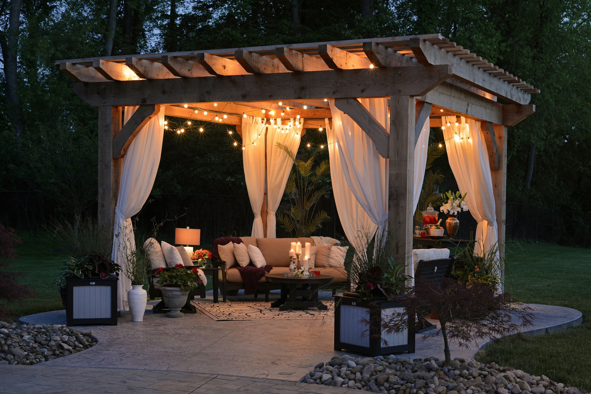 photo of gazebo with outdoor furniture and string lights at night