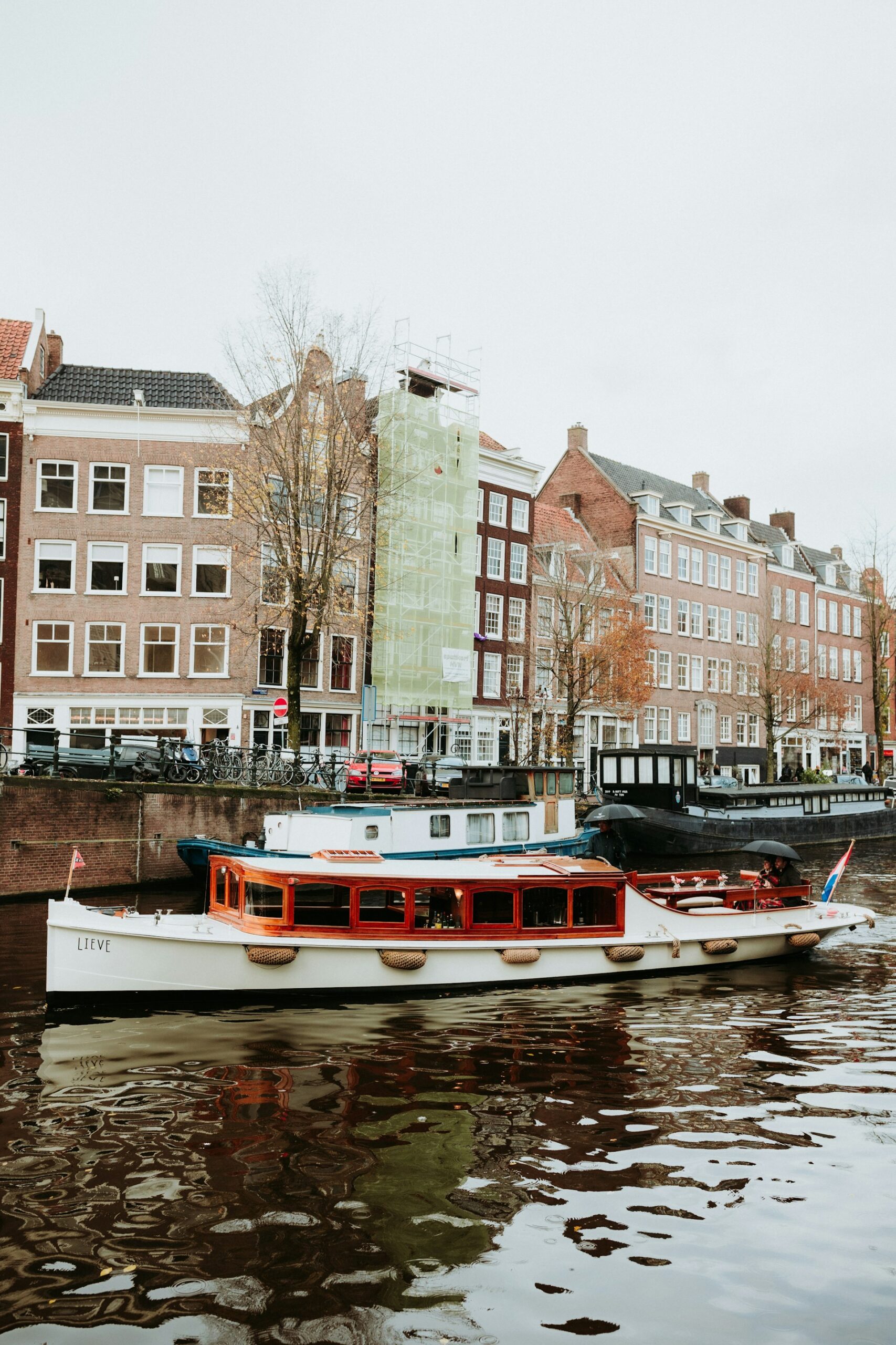 boats floating in the canal in Amsterdam