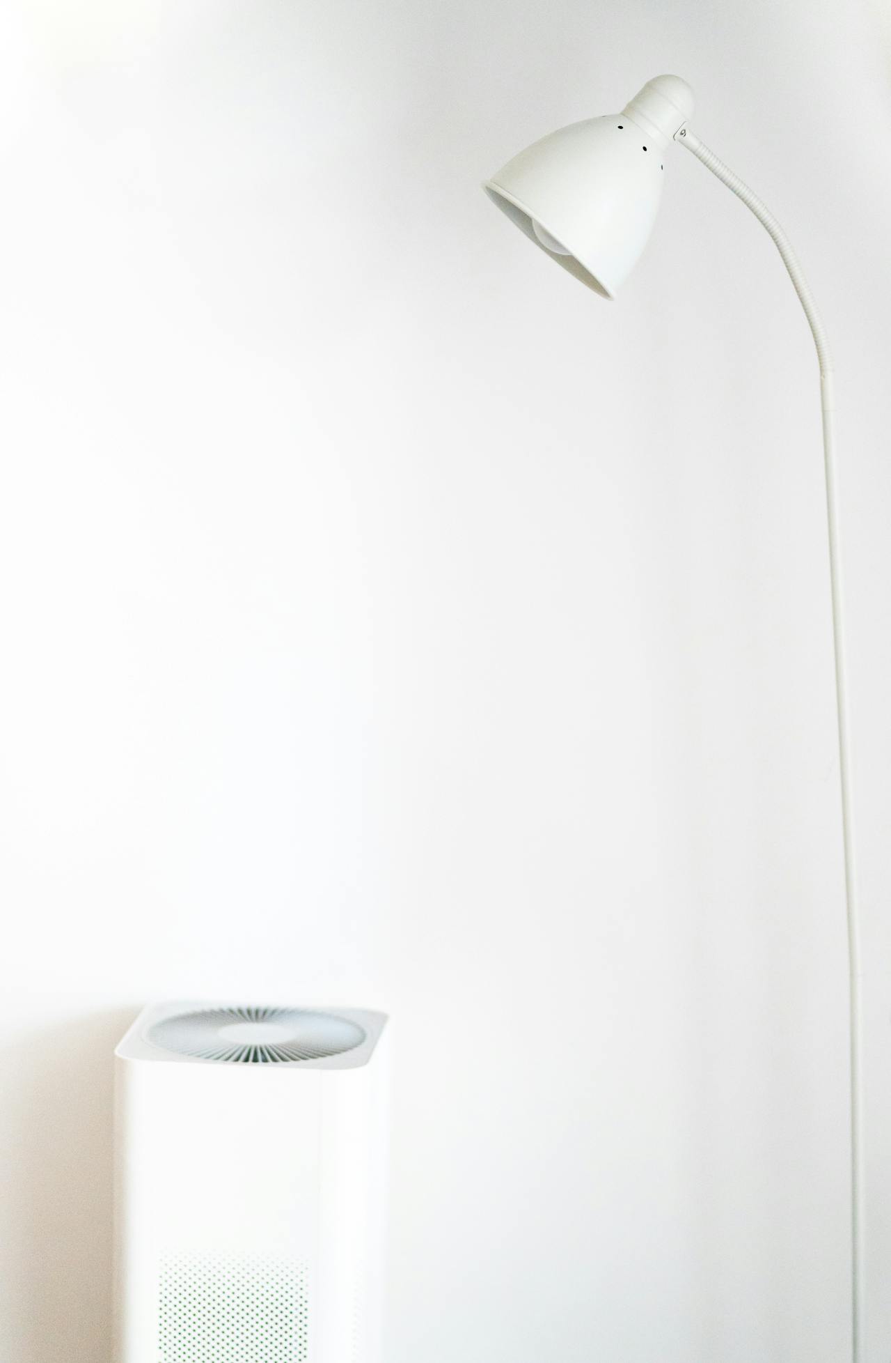 white floor lamp and air humidifier in front of white wall white floor lamp and air humidifier in front of white wall