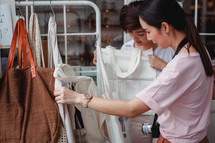 young Asian women shopping for cotton bags in a store young Asian women shopping for cotton bags in a store