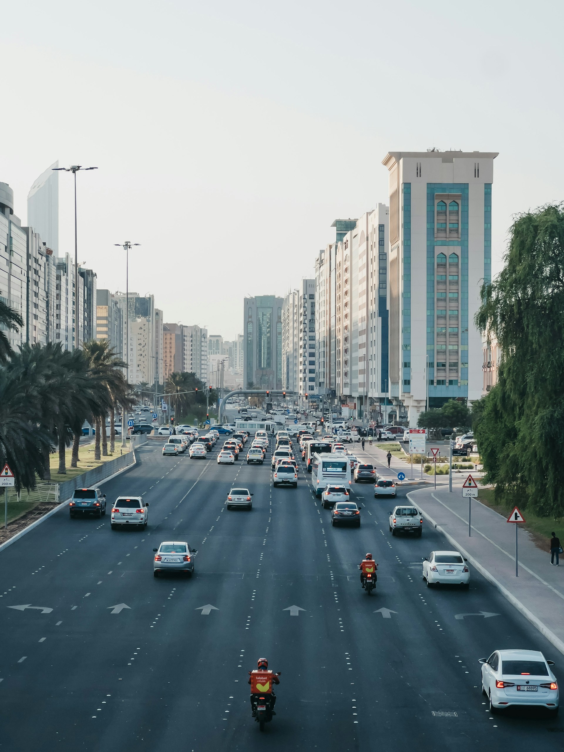 a busy road with cars and high-rise buildings in abu dhabi, UAE