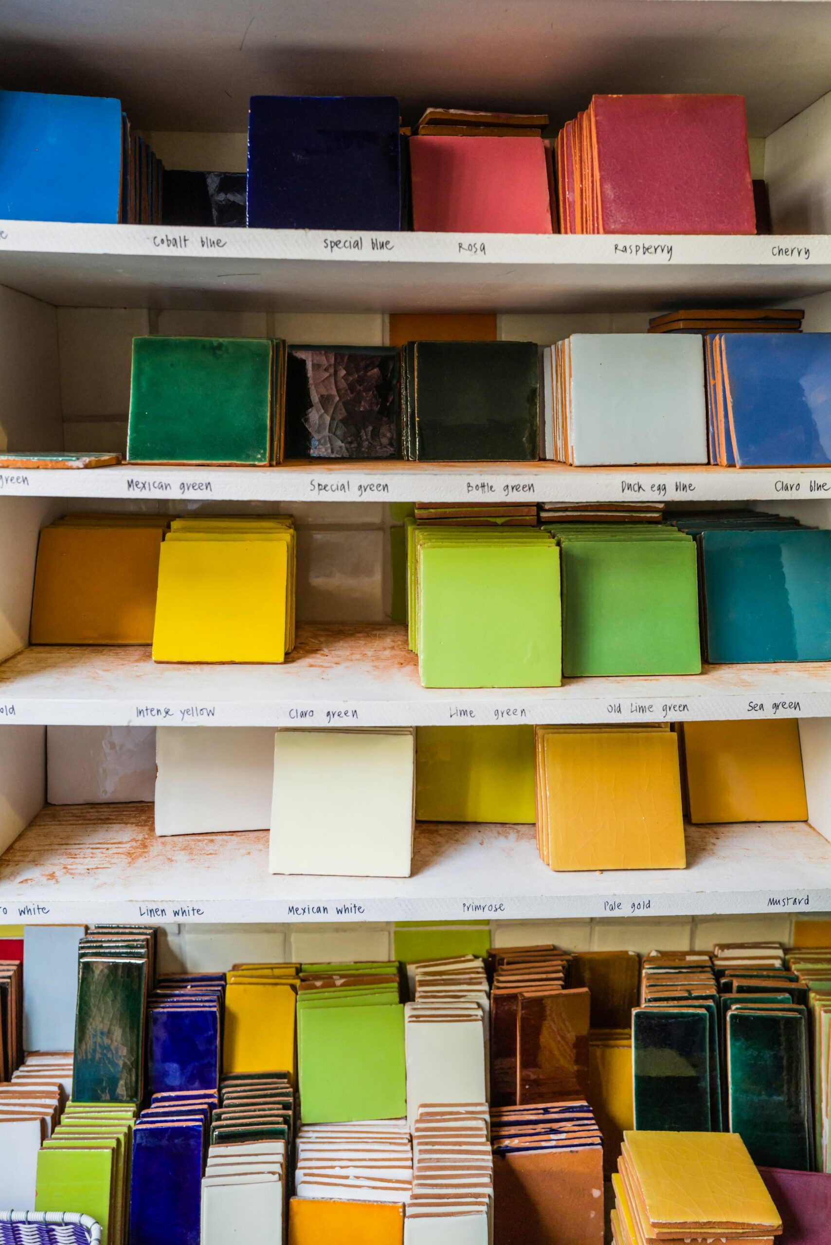 shelves filled with different coloured porcelain tiles