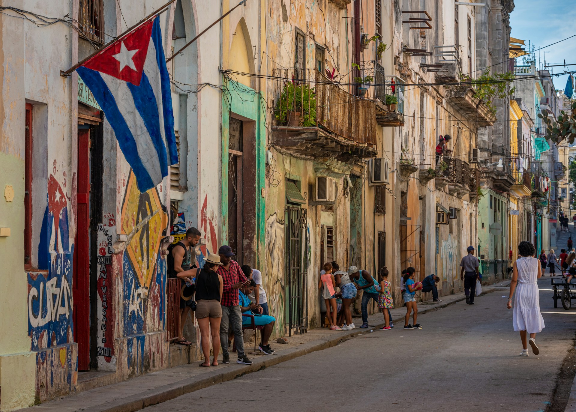 people walking on colourful street in Havana, Cuba people walking on colourful street in Havana, Cuba