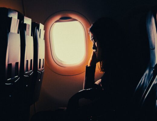 woman sleeping in an airplane near the window