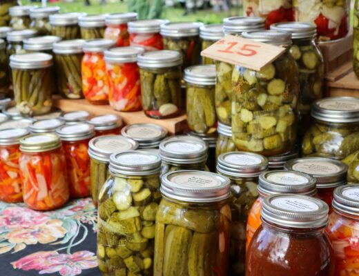 clear glass jars with kimchi and pickles at a food market