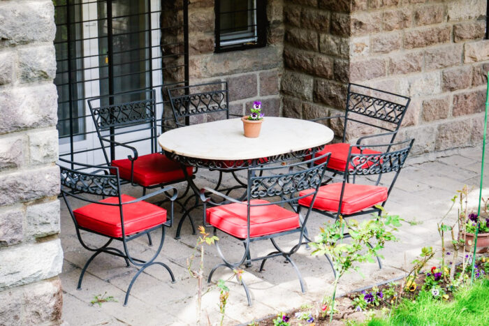 Cozy outdoor patio in Ankara with wrought iron furniture and vibrant red cushions, perfect for relaxation. Cozy outdoor patio in Ankara with wrought iron furniture and vibrant red cushions, perfect for relaxation.