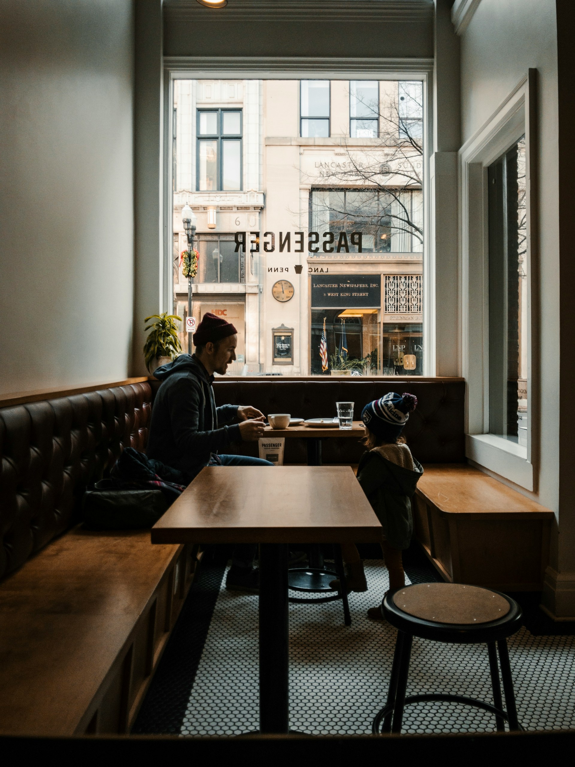 Young man with toddler sitting in a coffee shop