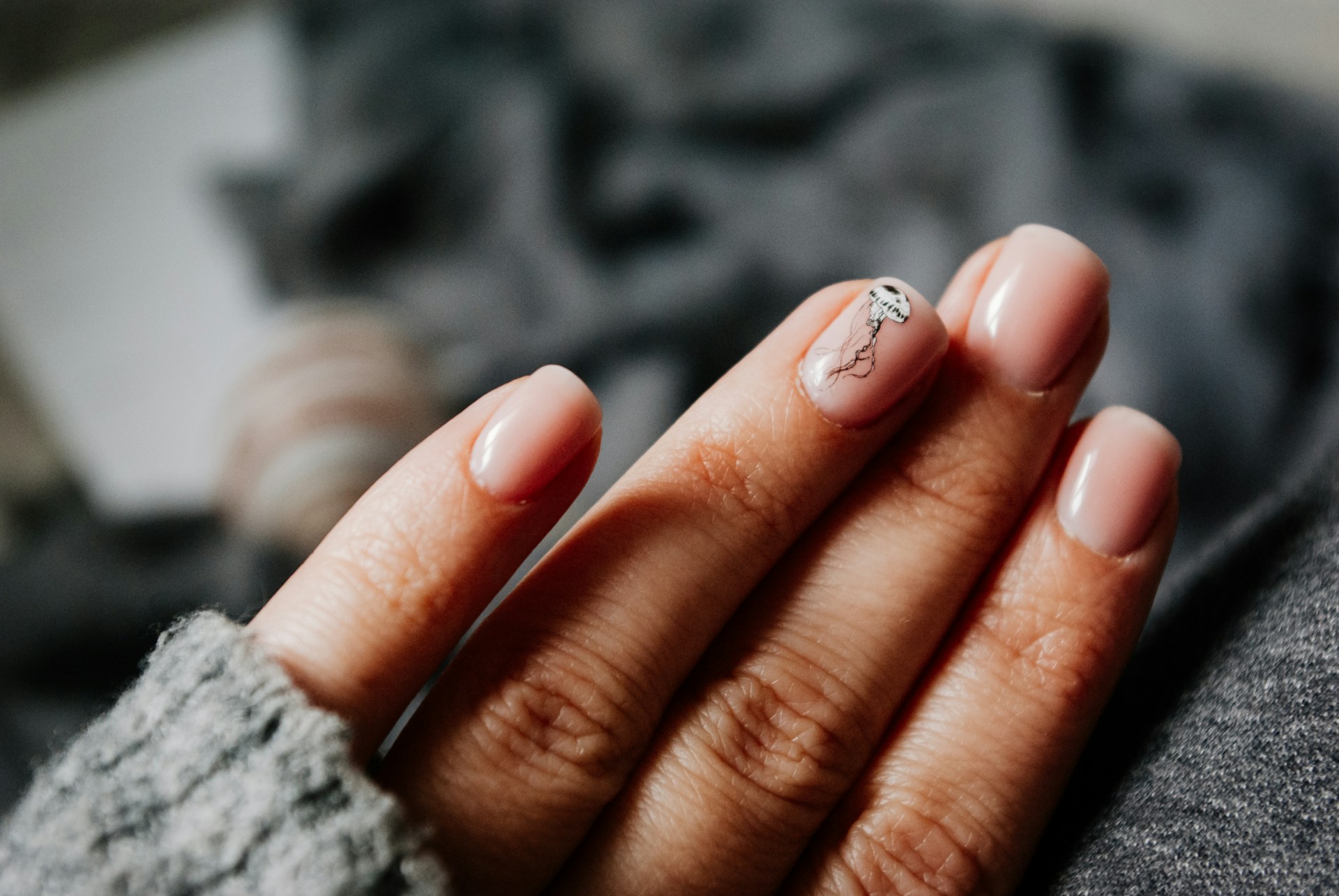 A woman's hand with natural nail polish manicure A woman's hand with natural nail polish manicure