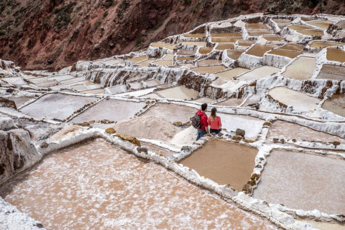 Tourists explore the ancient salt terraces of Maras in Peru's Sacred Valley.