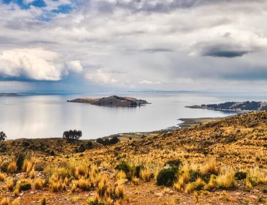 Breathtaking landscape of Lake Titicaca with a view of distant islands under dramatic skies.