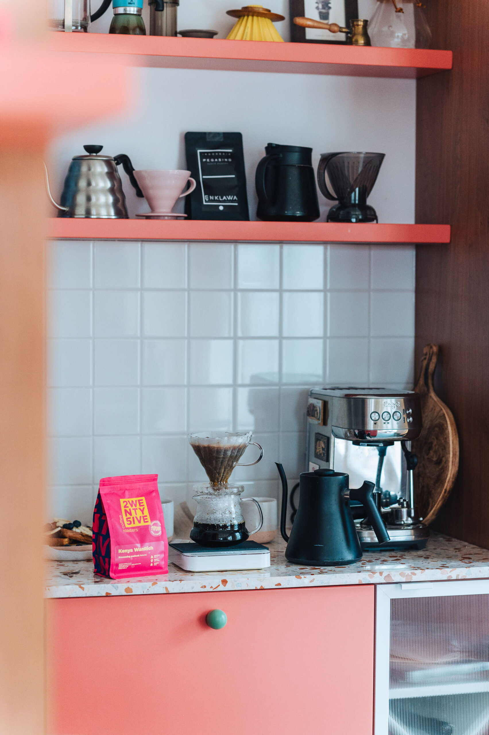 Brewing coffee with a V60 brewer in a home kitchen. Coffee bag on a marble counter. Brewing coffee with a V60 brewer in a home kitchen. Coffee bag on a marble counter.